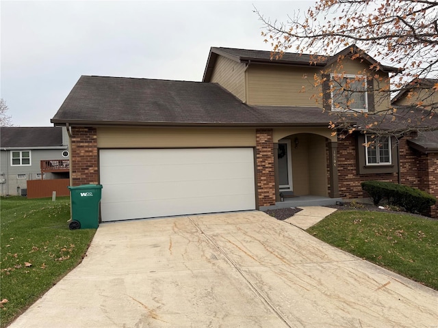 view of front facade with a garage and a front lawn