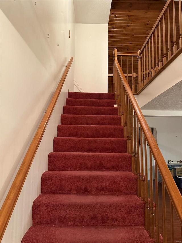 staircase with wood ceiling