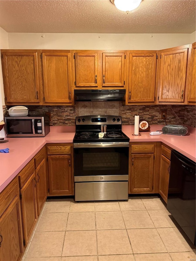 kitchen featuring tasteful backsplash, light tile patterned flooring, and appliances with stainless steel finishes