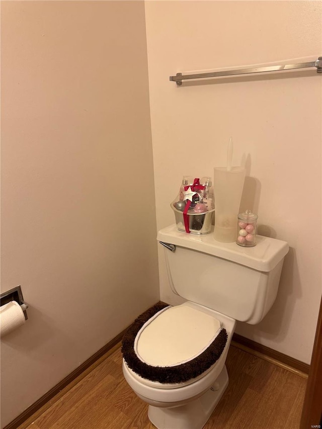 bathroom with hardwood / wood-style floors and toilet