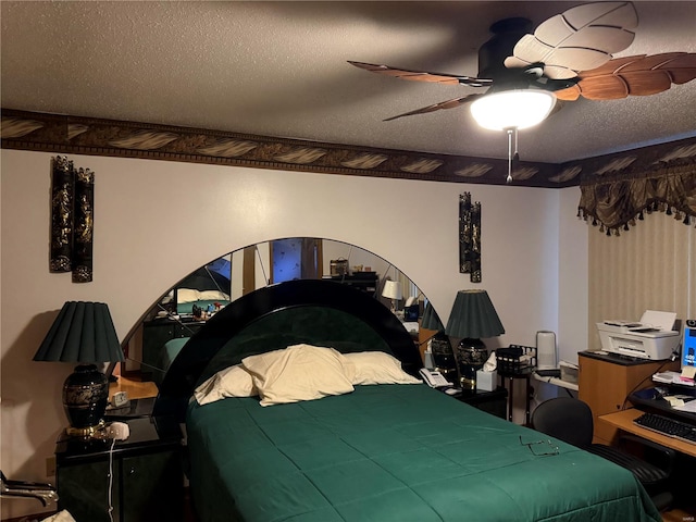 bedroom with a textured ceiling and ceiling fan