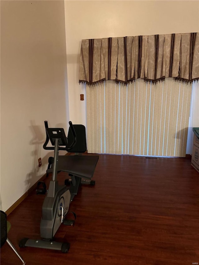 workout area featuring dark hardwood / wood-style floors