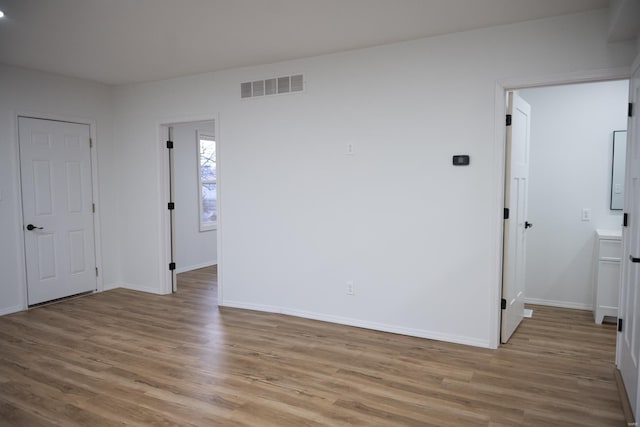 spare room with light hardwood / wood-style flooring