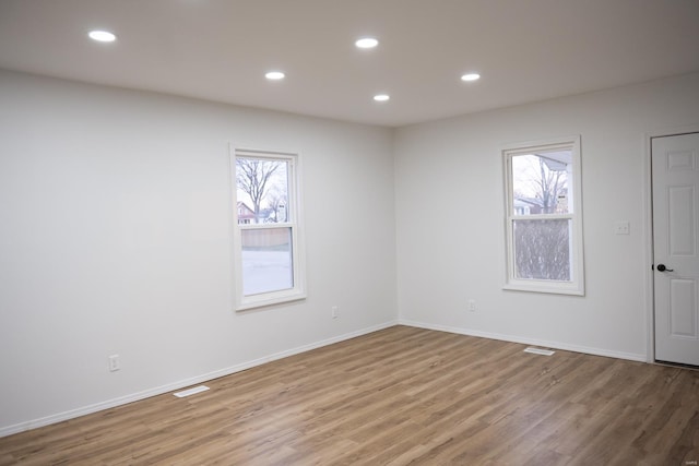 spare room with plenty of natural light and light wood-type flooring