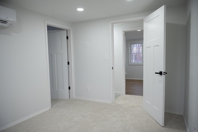 hall with carpet floors and a wall unit AC