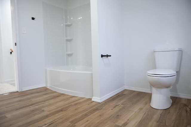 bathroom featuring shower / bathing tub combination, wood-type flooring, and toilet