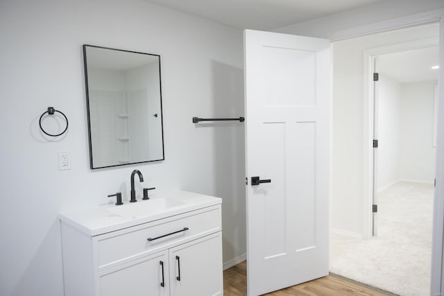 bathroom with vanity and wood-type flooring