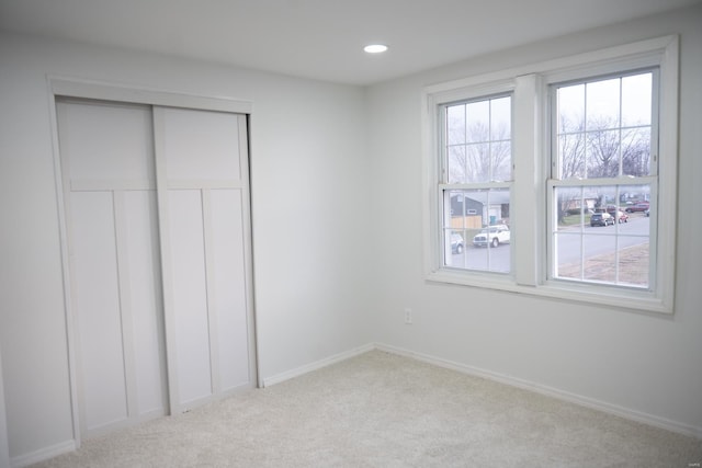 unfurnished bedroom with light colored carpet