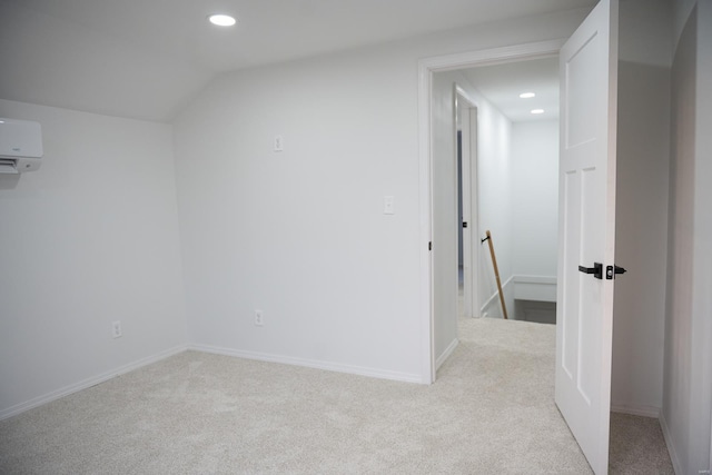 additional living space with light carpet, an AC wall unit, and lofted ceiling