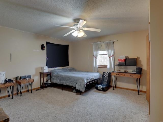 bedroom featuring a textured ceiling, baseboards, a ceiling fan, and light colored carpet