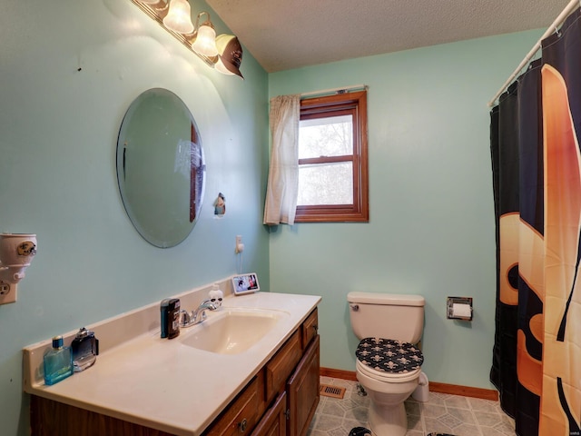 bathroom with visible vents, baseboards, toilet, a textured ceiling, and vanity