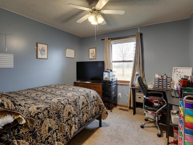 bedroom with a textured ceiling, ceiling fan, and light colored carpet