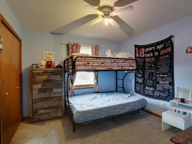 bedroom featuring carpet, baseboards, and a textured ceiling