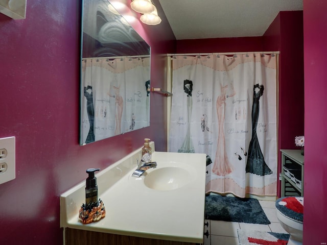 full bathroom with curtained shower, vanity, toilet, and tile patterned floors