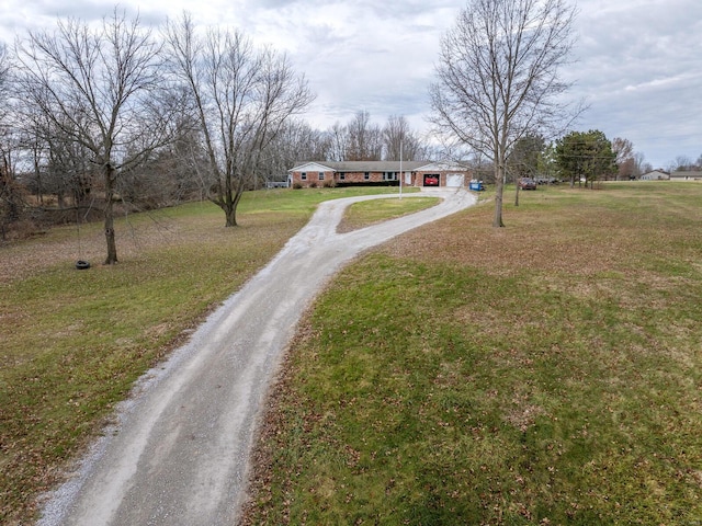 view of road featuring dirt driveway