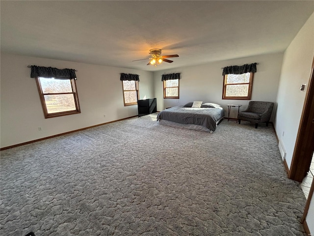 carpeted bedroom featuring ceiling fan and baseboards