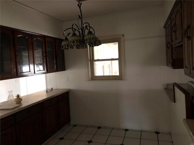 kitchen with dark brown cabinets and an inviting chandelier