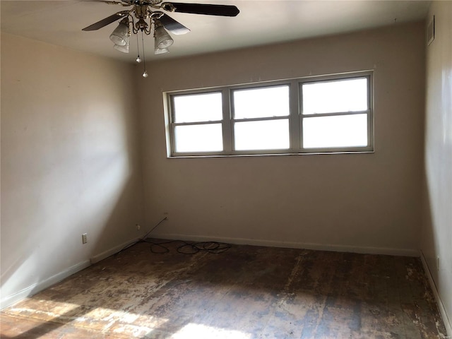 unfurnished room with a wealth of natural light, ceiling fan, and wood-type flooring