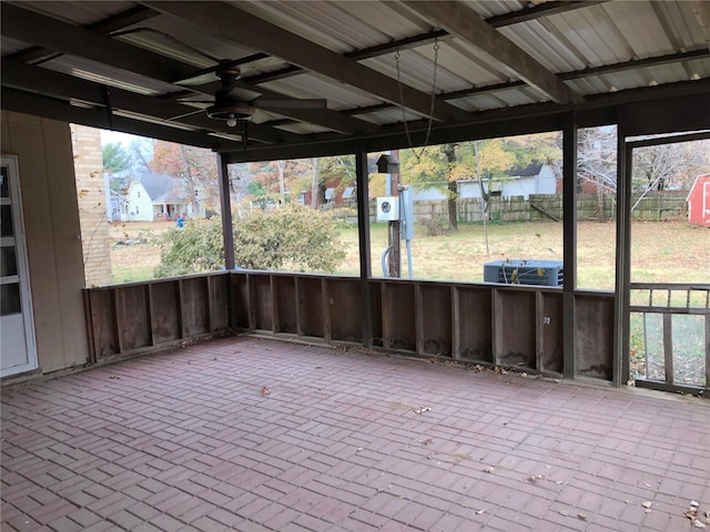 unfurnished sunroom with ceiling fan