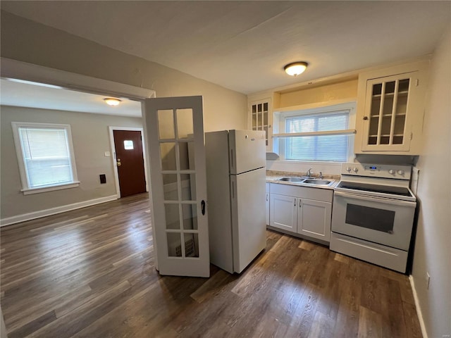 kitchen featuring sink, white cabinets, dark wood-type flooring, and white appliances