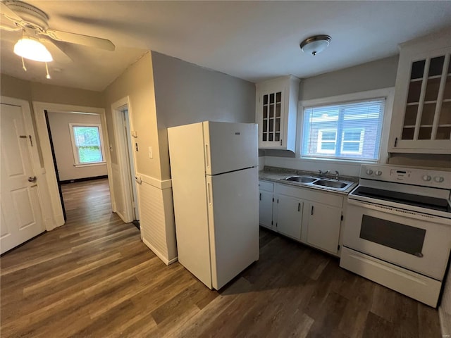 kitchen with white cabinetry, plenty of natural light, and white appliances