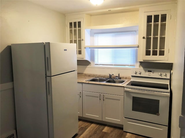 kitchen featuring dark hardwood / wood-style flooring, sink, electric stove, white cabinets, and white fridge