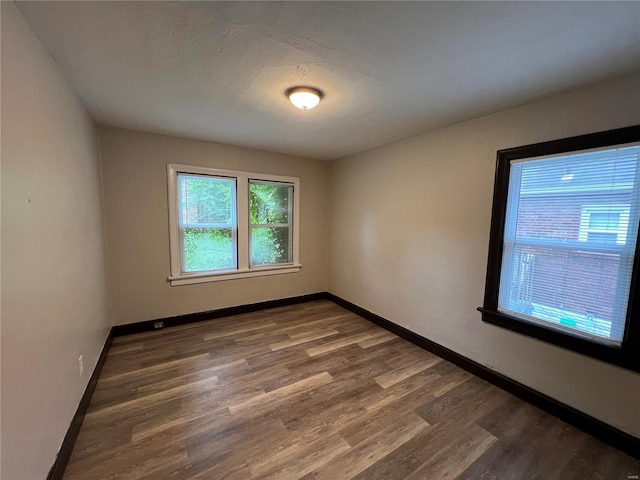 empty room featuring dark wood-type flooring