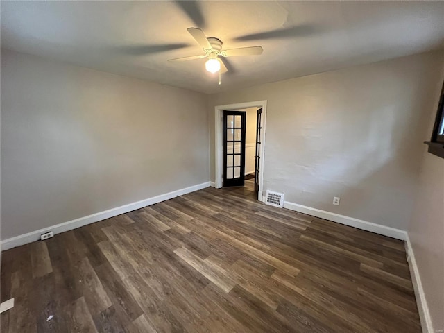 unfurnished room featuring ceiling fan and dark wood-type flooring