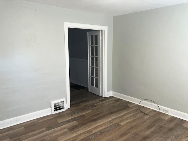 unfurnished room featuring dark wood-type flooring