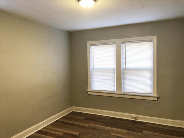 empty room featuring dark hardwood / wood-style flooring