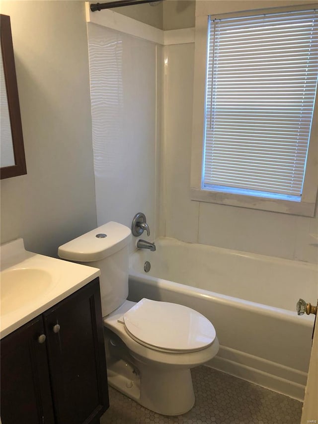 full bathroom with shower / bathing tub combination, tile patterned flooring, vanity, and toilet