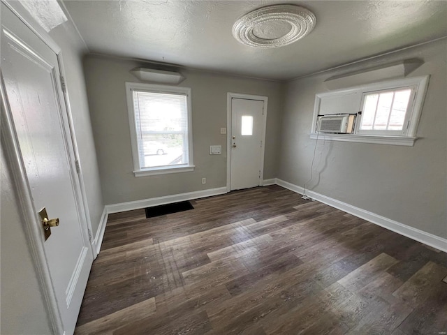 entryway with cooling unit, dark wood-type flooring, and ornamental molding