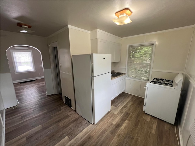 kitchen with white cabinets, white appliances, and dark hardwood / wood-style floors