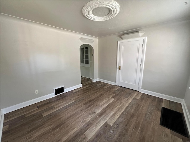 spare room with dark hardwood / wood-style flooring