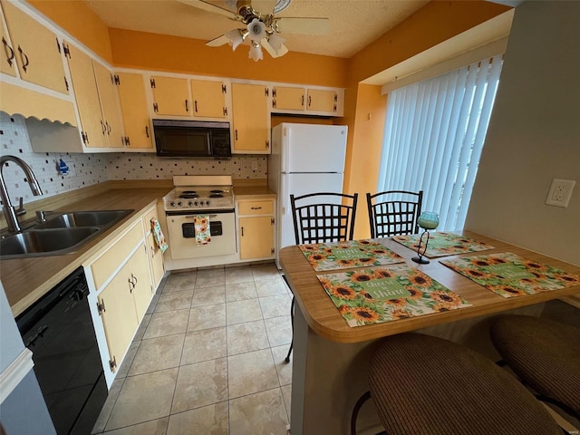 kitchen featuring a textured ceiling, ceiling fan, sink, black appliances, and light tile patterned flooring