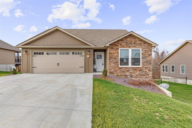 view of front of property featuring a front yard and a garage