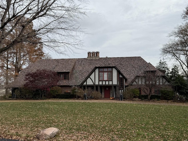 tudor home with a front yard