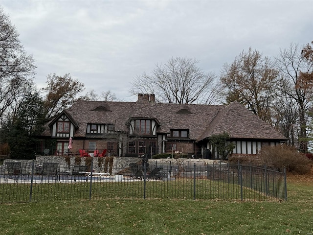 tudor home featuring a front yard