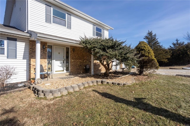 view of front of property with brick siding and a front lawn