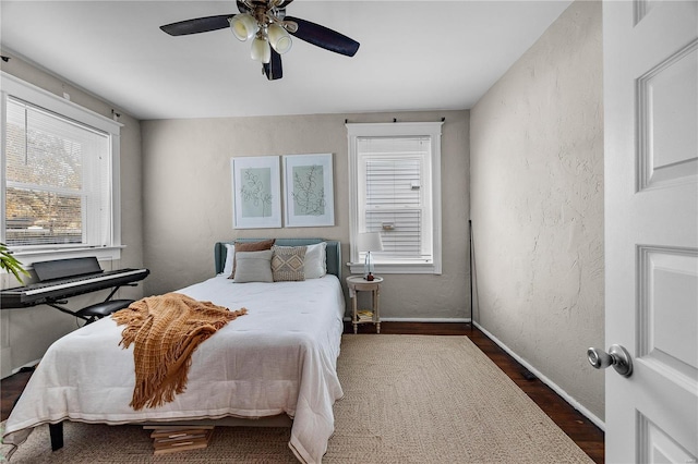 bedroom featuring ceiling fan and dark wood-type flooring