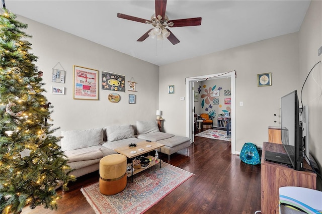 living room featuring ceiling fan and dark wood-type flooring