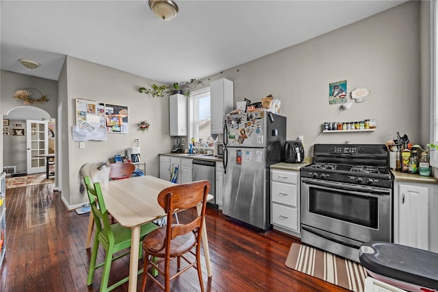 kitchen with white cabinetry, dark wood-type flooring, and stainless steel appliances