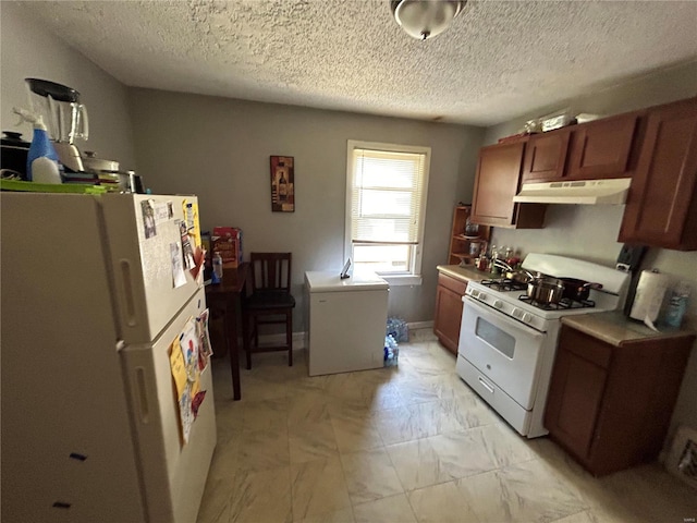 kitchen with white appliances and a textured ceiling