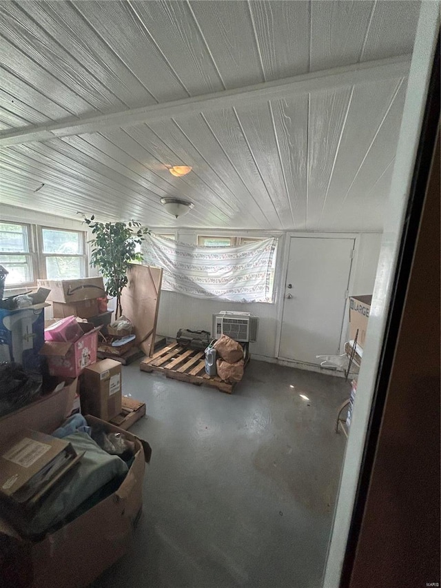 interior space featuring concrete flooring and a wall mounted AC