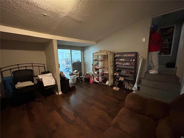 interior space featuring wood-type flooring and a textured ceiling