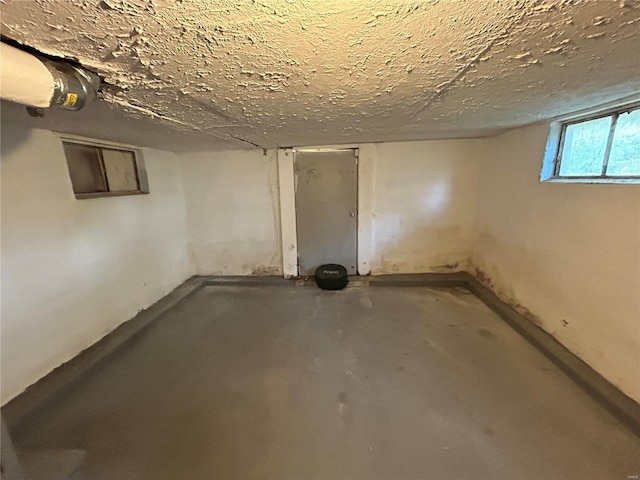 basement featuring a textured ceiling