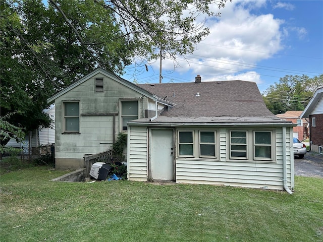 rear view of house with a yard