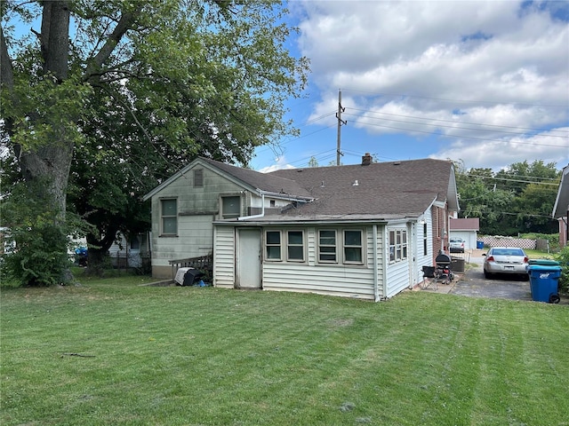 back of house featuring a yard