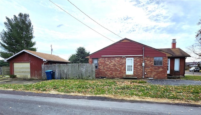 view of property exterior featuring a garage and an outbuilding