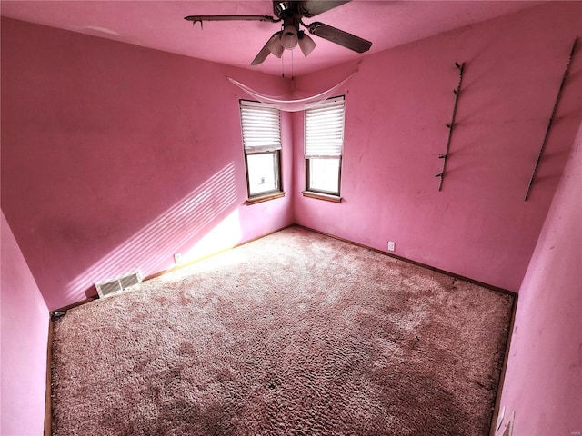 carpeted spare room with ceiling fan